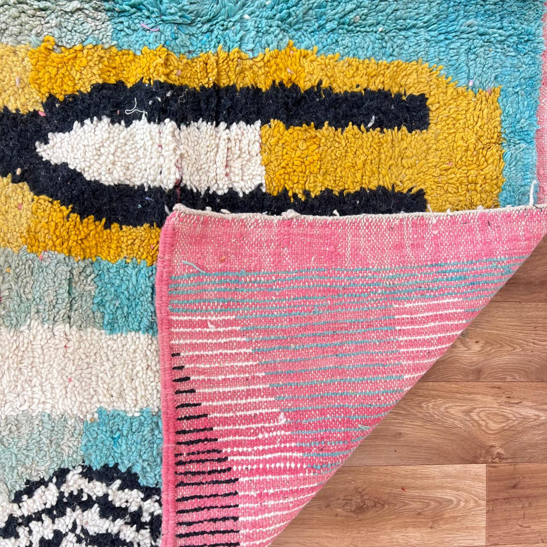 Vintage Moroccan wool rug 857 – handmade abstract Berber carpet in turquoise, black, pink, and mustard tones (290 × 205 cm / 9.51 × 6.72 ft).