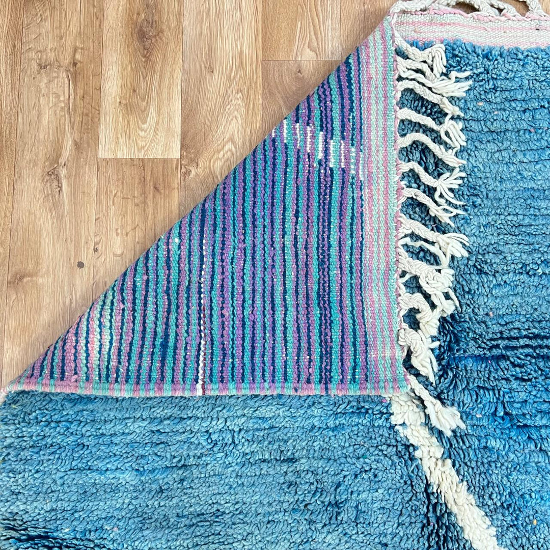 Vintage Moroccan wool rug BM31 – handmade blue, pink, and yellow abstract geometric design (253 × 148 cm).