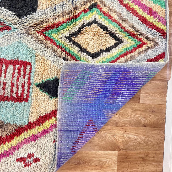 Vintage Moroccan wool rug 137 – handmade colorful geometric Berber design in turquoise, red, and yellow tones (256 × 156 cm).