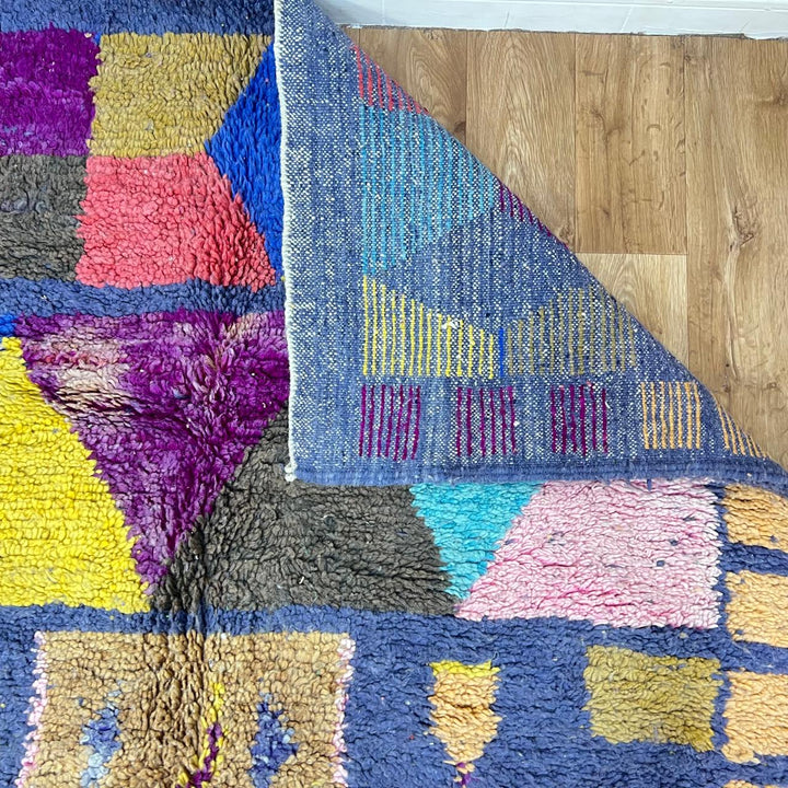 Vintage Moroccan wool rug 158 – handmade geometric colorful pattern in blue, purple, and mustard tones (264 × 147 cm).