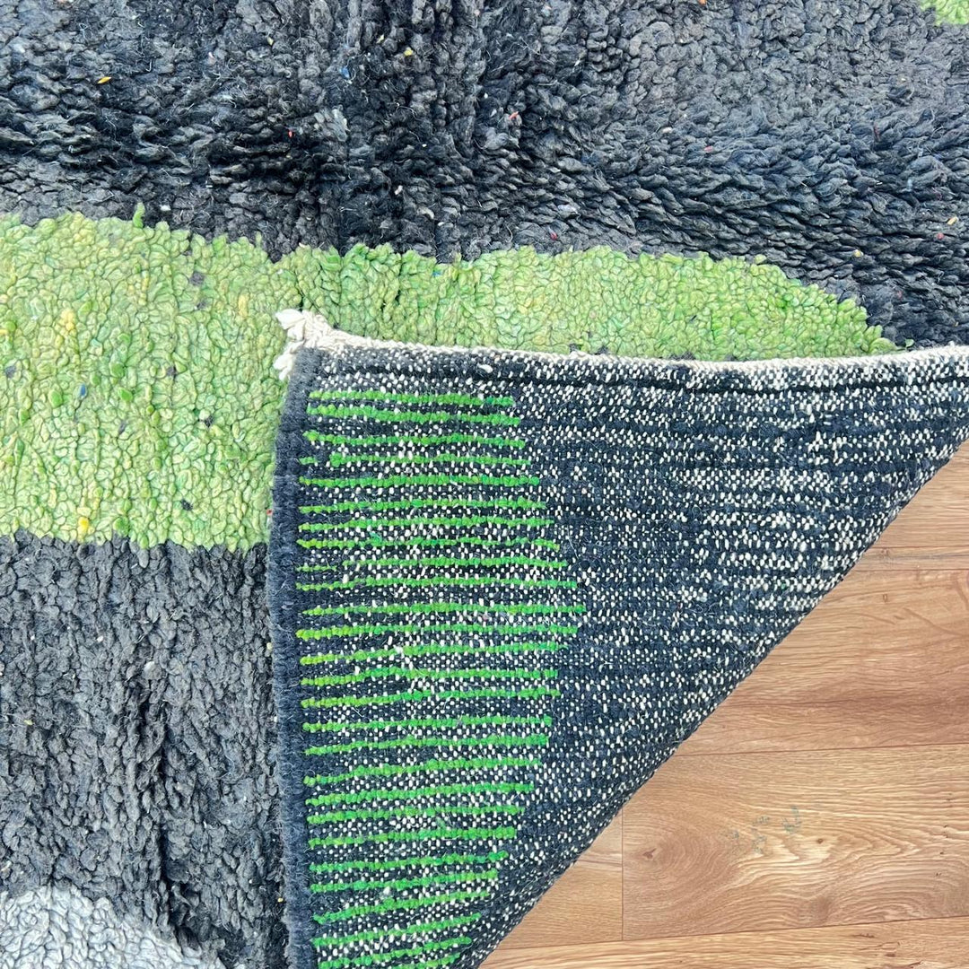 Vintage Moroccan wool rug 731 – handmade Berber carpet with black, green, pink, and grey abstract tribal patterns (233 × 147 cm / 7.64 × 4.82 ft).