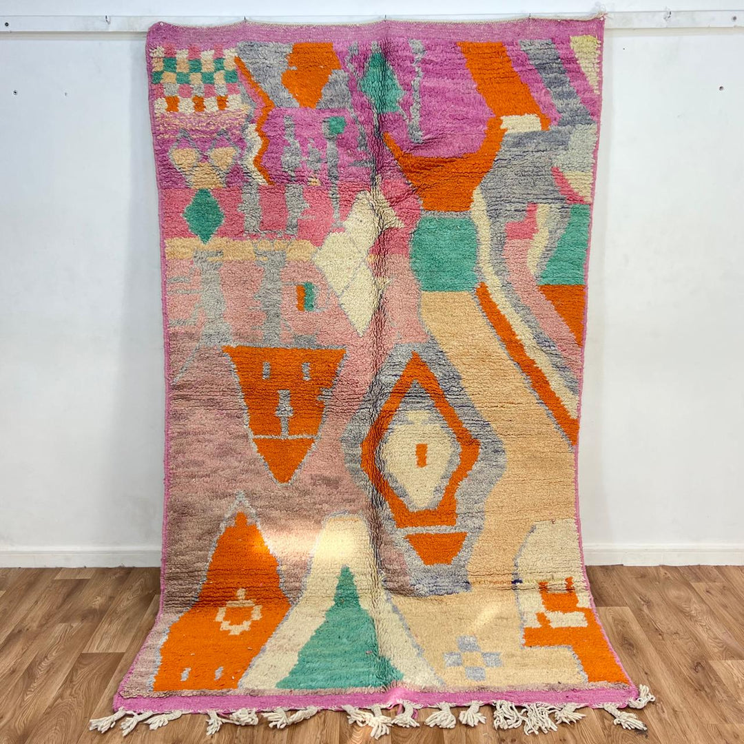 Vintage Moroccan wool rug in pink and orange tones with abstract Berber geometric patterns, handmade in Morocco