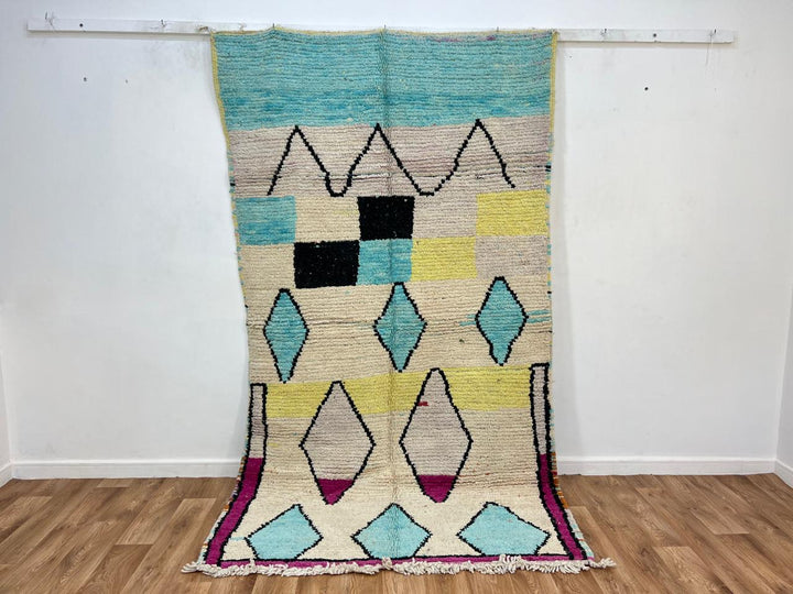 Vintage Moroccan wool rug 697 – handmade geometric cream, blue, and yellow Berber rug, 255 × 143 cm (8.36 × 4.69 ft).