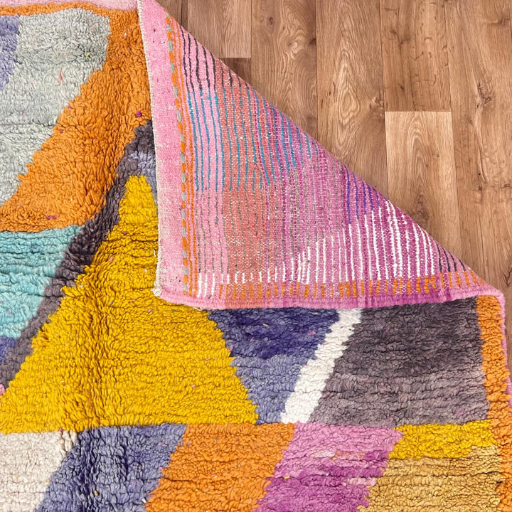 Vintage Moroccan wool rug 257 – handmade Berber rug with vibrant geometric design in orange, yellow, purple, and blue (264 × 162 cm).
