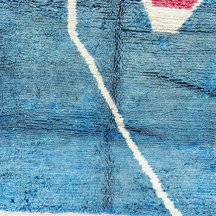 Vintage Moroccan wool rug BM31 – handmade blue, pink, and yellow abstract geometric design (253 × 148 cm).