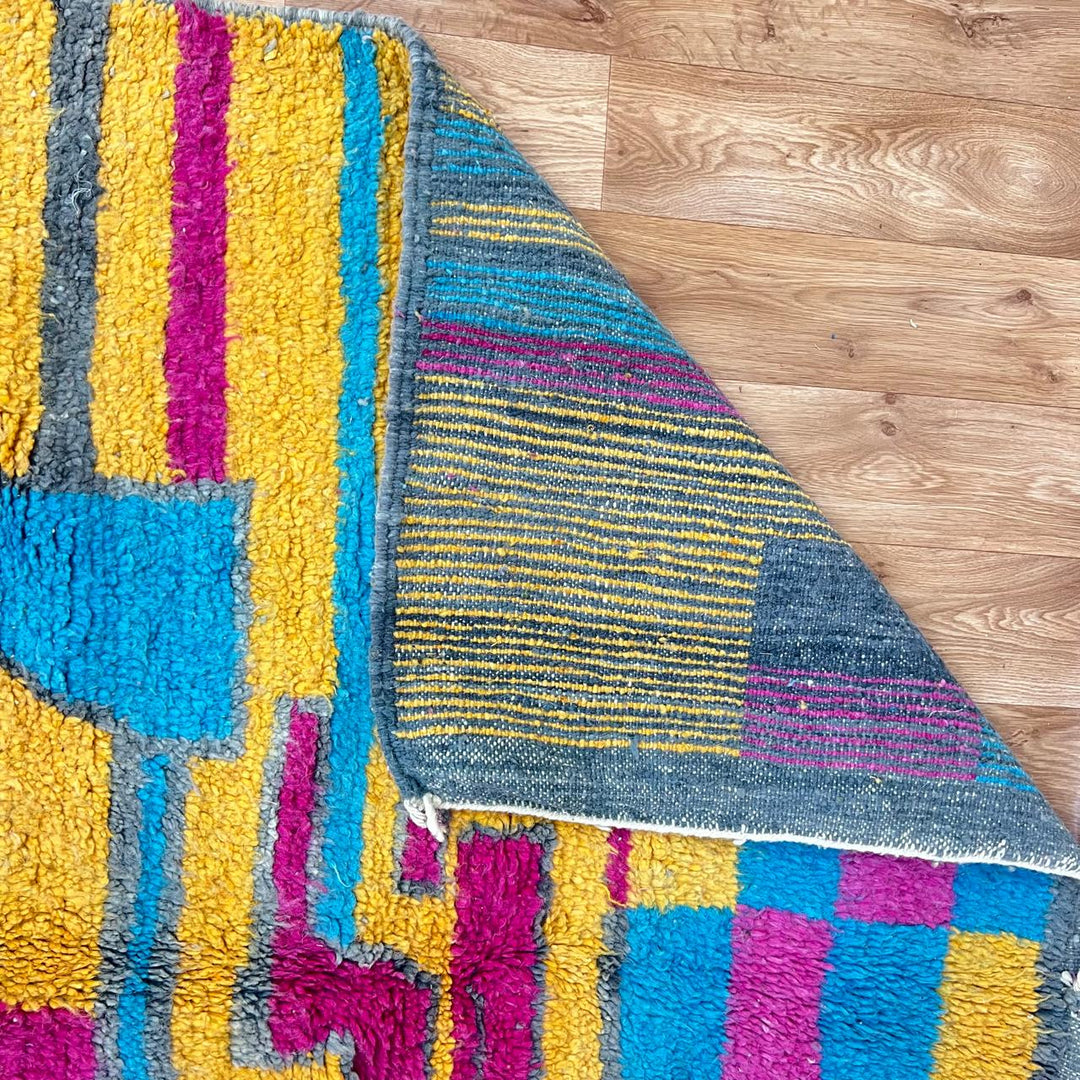 Vintage Moroccan wool rug 193 – handmade colorful abstract Moroccan wool rug in pink, yellow, and blue (250 × 165 cm).