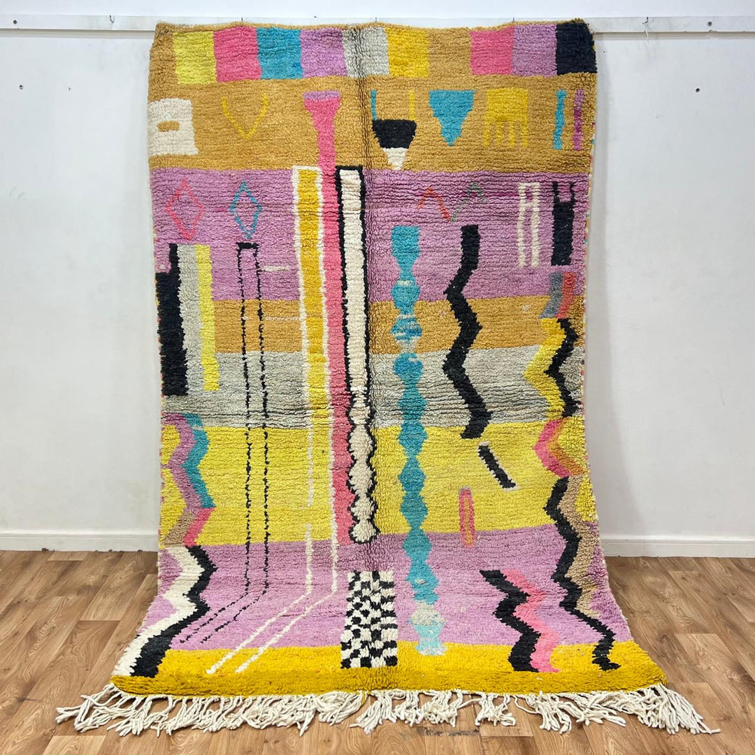 Vintage Moroccan wool rug 729 – handmade pink, yellow, and blue Berber carpet with abstract geometric tribal motifs, 268 × 164 cm (8.79 × 5.38 ft).