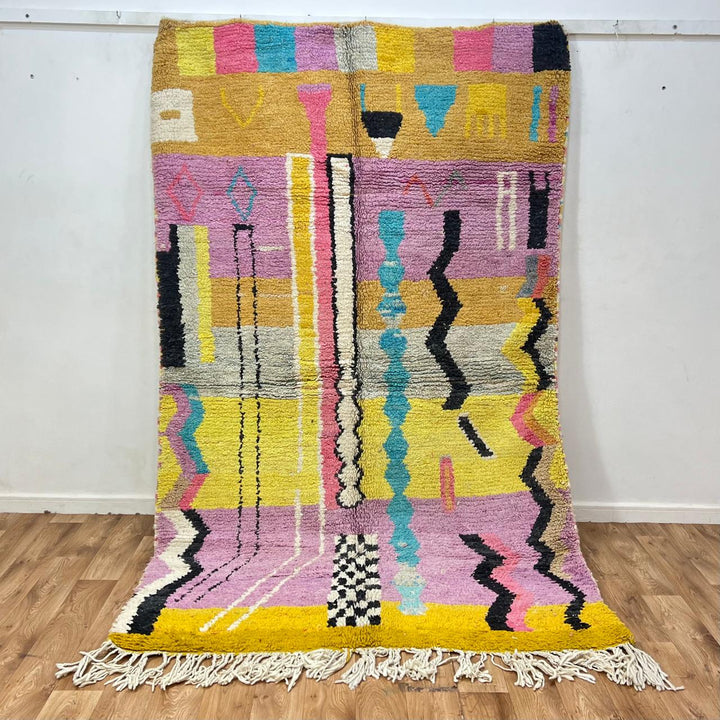 Vintage Moroccan wool rug 729 – handmade pink, yellow, and blue Berber carpet with abstract geometric tribal motifs, 268 × 164 cm (8.79 × 5.38 ft).