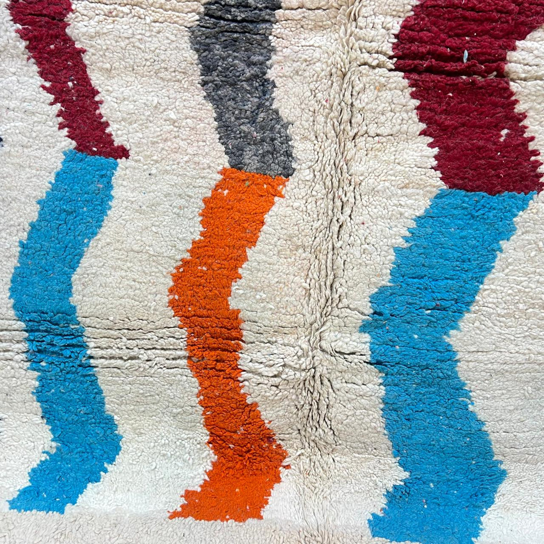 Vintage Moroccan wool rug 136 – handmade wavy pattern in blue, orange, red, and gray tones (221 × 150 cm).