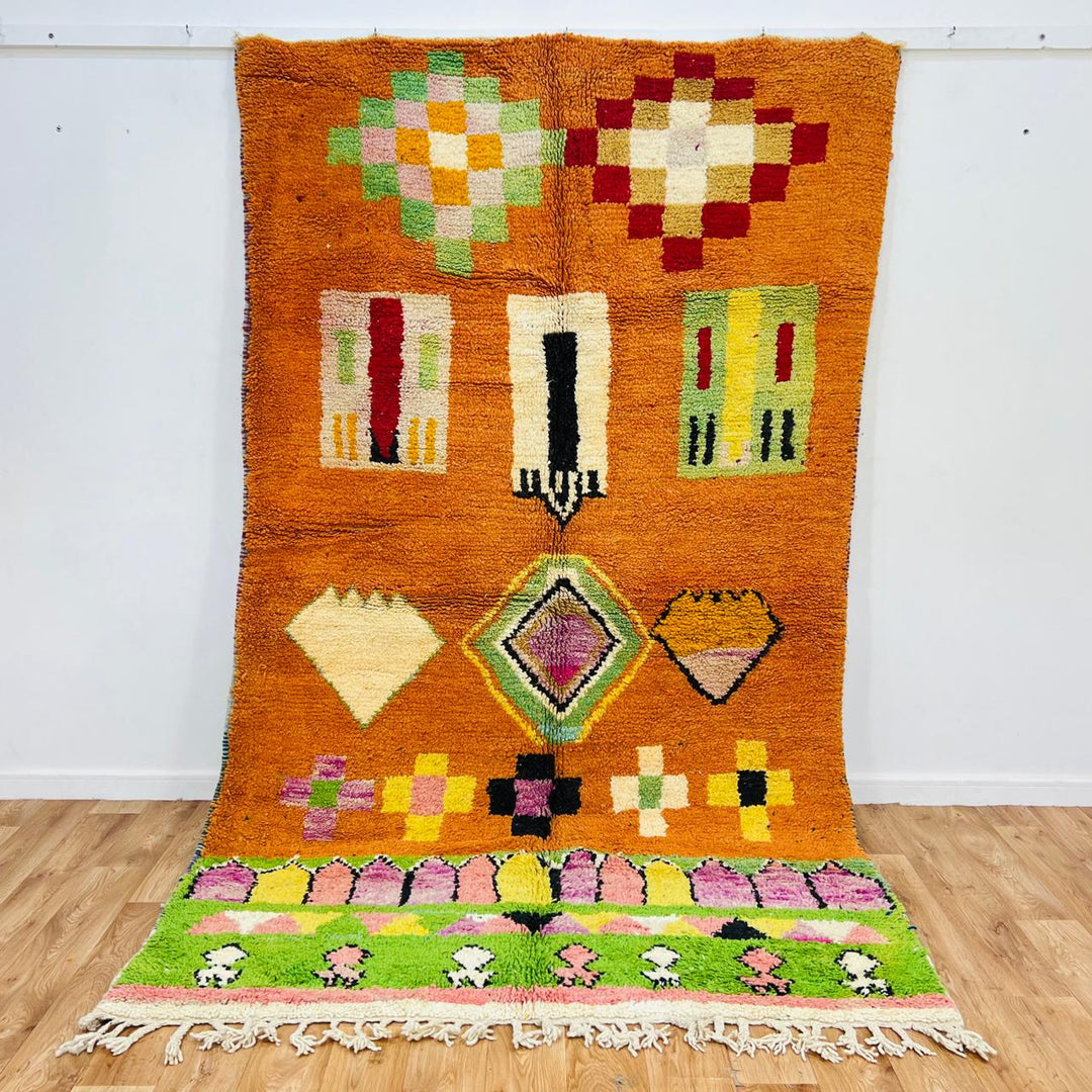 Vintage Moroccan wool rug with orange base and colorful Berber geometric patterns, handmade in Morocco