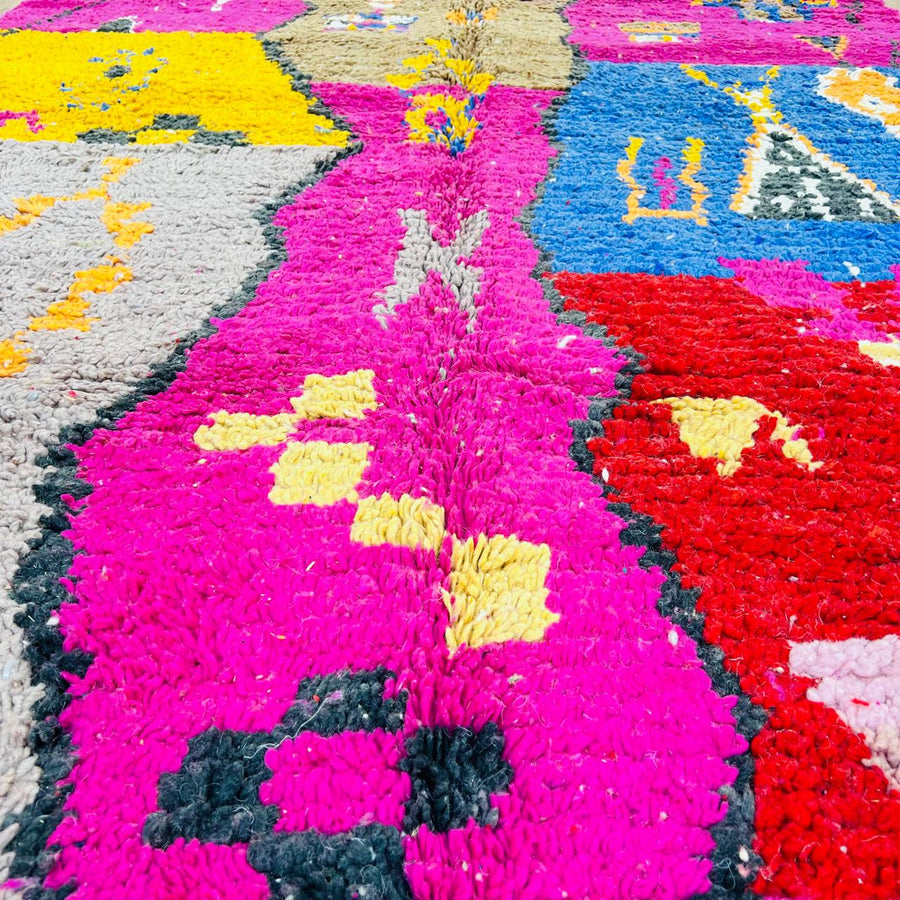 Vintage Moroccan rug with colorful Berber geometric patterns in pink, yellow, blue and red, handmade wool carpet from Morocco