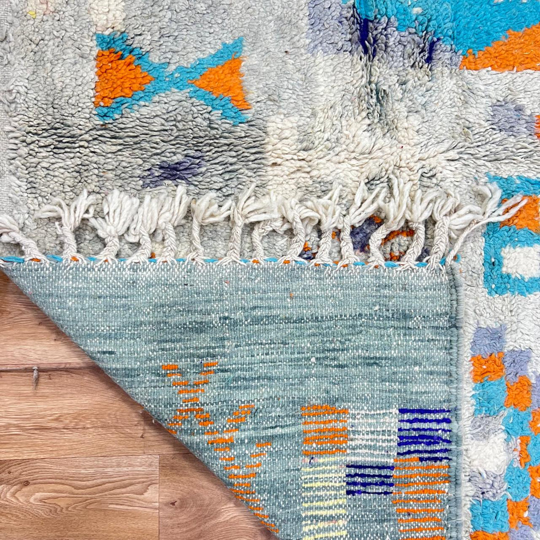 Vintage Moroccan wool rug 782 – cream and colorful handmade Berber carpet with geometric orange, turquoise, and grey patterns, 271 × 170 cm (8.89 × 5.57 ft).