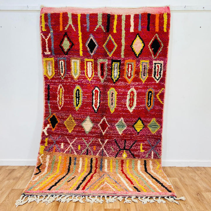 Vintage Moroccan wool rug with red base, colorful Berber diamond patterns, handmade tribal carpet