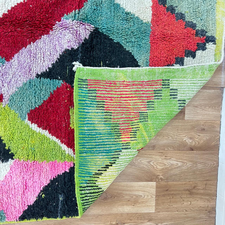 Vintage Moroccan wool rug 210 – handmade colorful geometric Berber design in red, green, pink, and cream (282 × 158 cm).