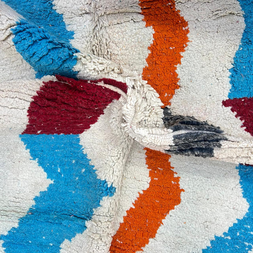 Vintage Moroccan wool rug 136 – handmade wavy pattern in blue, orange, red, and gray tones (221 × 150 cm).