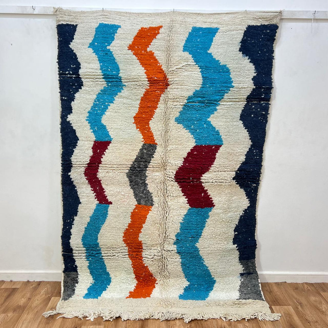 Vintage Moroccan wool rug 136 – handmade wavy pattern in blue, orange, red, and gray tones (221 × 150 cm).