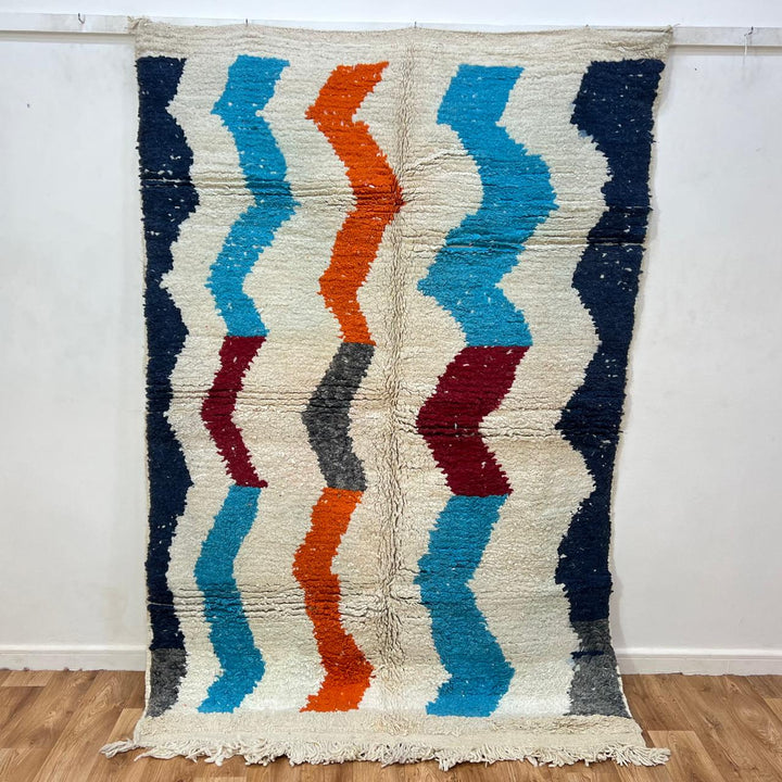Vintage Moroccan wool rug 136 – handmade wavy pattern in blue, orange, red, and gray tones (221 × 150 cm).