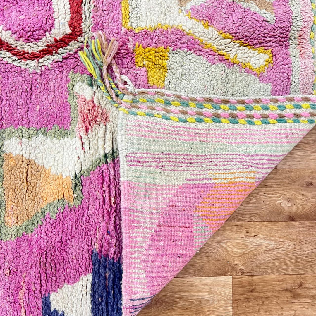 Vintage Moroccan wool rug 743 – handmade Berber carpet in pink with colorful geometric motifs in red, yellow, green, and blue, 268 × 144 cm (8.79 × 4.72 ft).