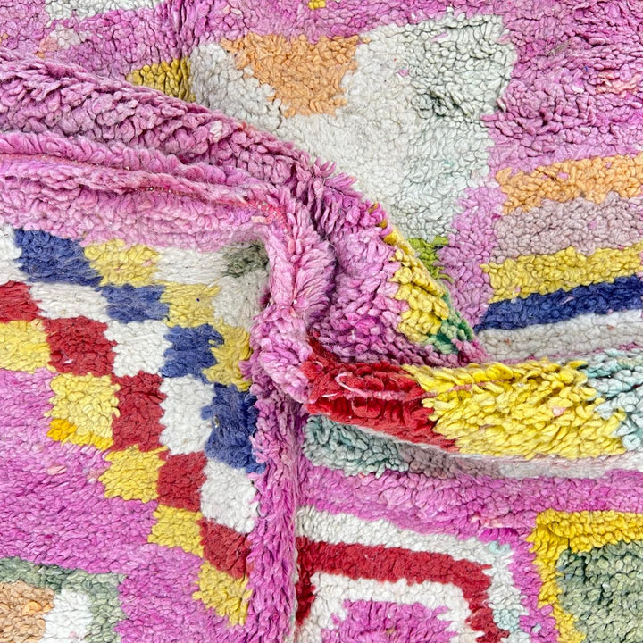 Vintage Moroccan wool rug 743 – handmade Berber carpet in pink with colorful geometric motifs in red, yellow, green, and blue, 268 × 144 cm (8.79 × 4.72 ft).