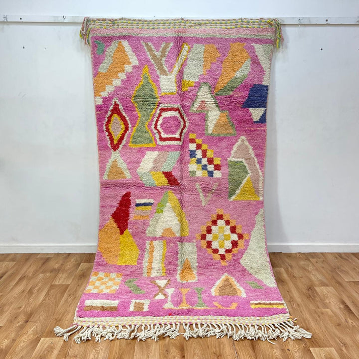 Vintage Moroccan wool rug 743 – handmade Berber carpet in pink with colorful geometric motifs in red, yellow, green, and blue, 268 × 144 cm (8.79 × 4.72 ft).