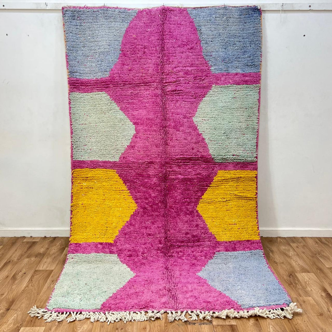 Vintage Moroccan wool rug 141 – handmade geometric pattern in pink, yellow, and blue tones (268 × 161 cm).