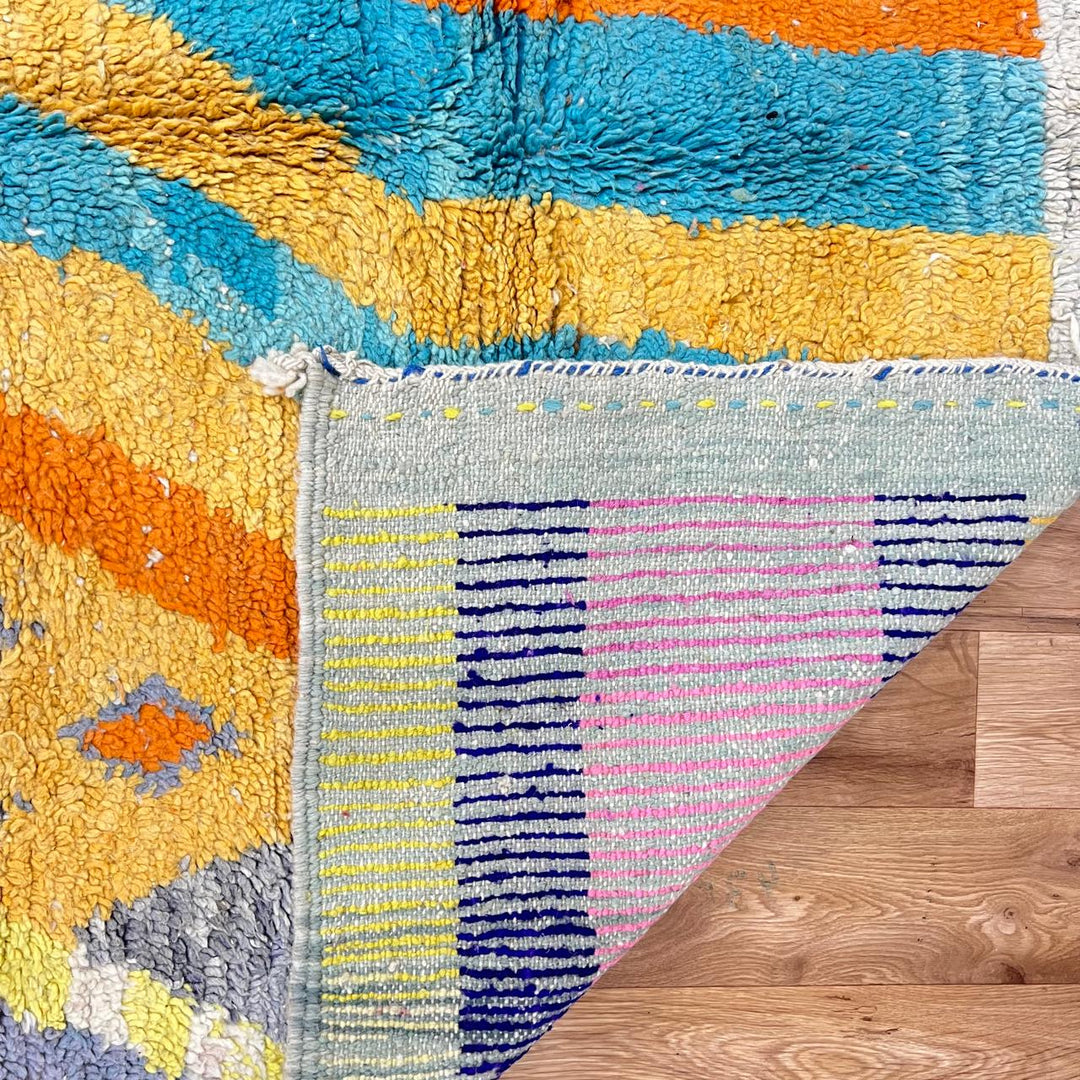 Vintage Moroccan wool rug 782 – cream and colorful handmade Berber carpet with geometric orange, turquoise, and grey patterns, 271 × 170 cm (8.89 × 5.57 ft).