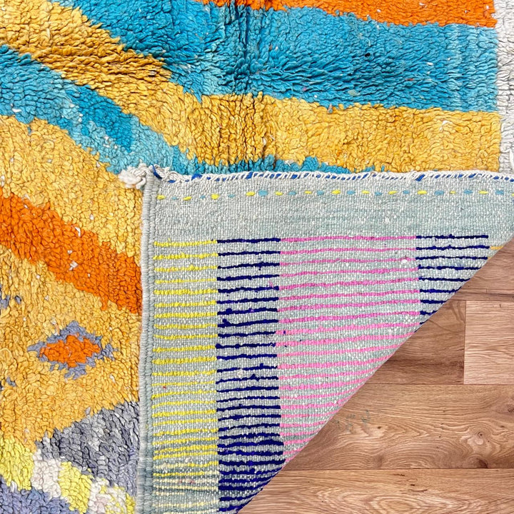 Vintage Moroccan wool rug 782 – cream and colorful handmade Berber carpet with geometric orange, turquoise, and grey patterns, 271 × 170 cm (8.89 × 5.57 ft).