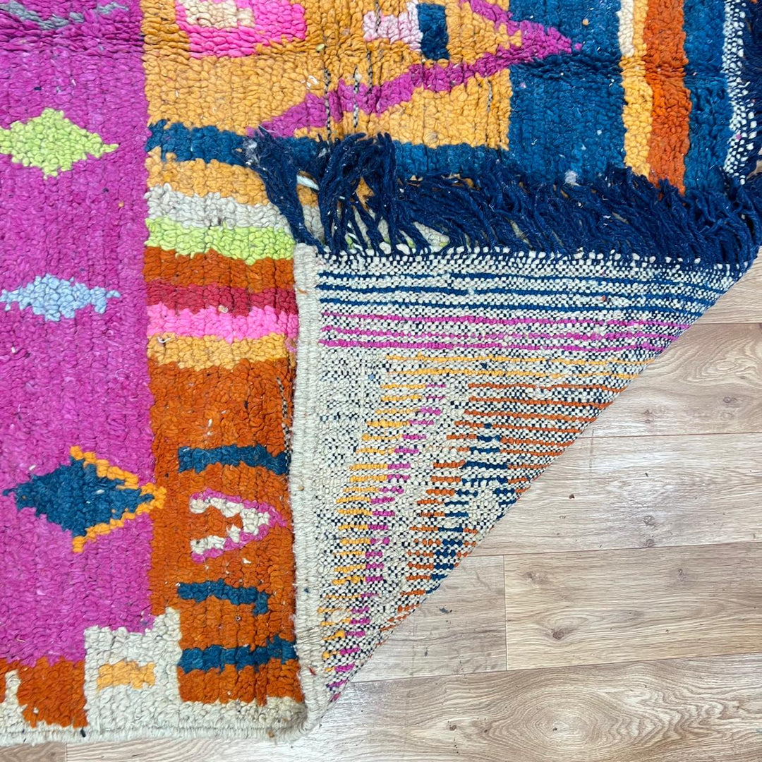 Vintage Moroccan wool rug 138 – handmade colorful geometric Berber design with pink, blue, and orange tones (234 × 162 cm).