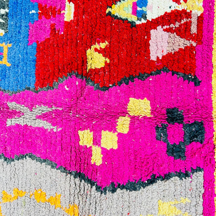 Vintage Moroccan rug with colorful Berber geometric patterns in pink, yellow, blue and red, handmade wool carpet from Morocco