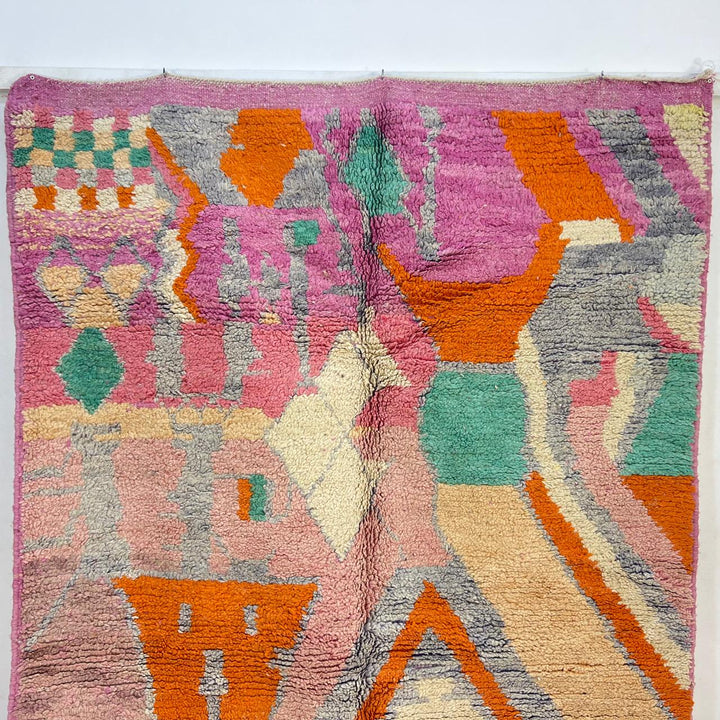 Vintage Moroccan wool rug in pink and orange tones with abstract Berber geometric patterns, handmade in Morocco