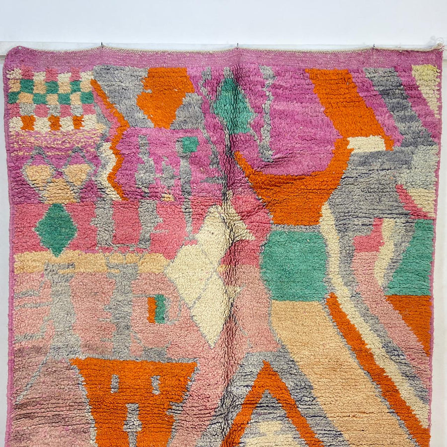 Vintage Moroccan wool rug in pink and orange tones with abstract Berber geometric patterns, handmade in Morocco