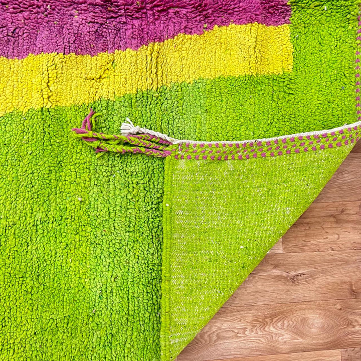 Vintage Moroccan wool rug 877 – handmade Berber carpet with lime green base and pink-yellow abstract stripe, 299 × 206 cm (9.81 × 6.75 ft).