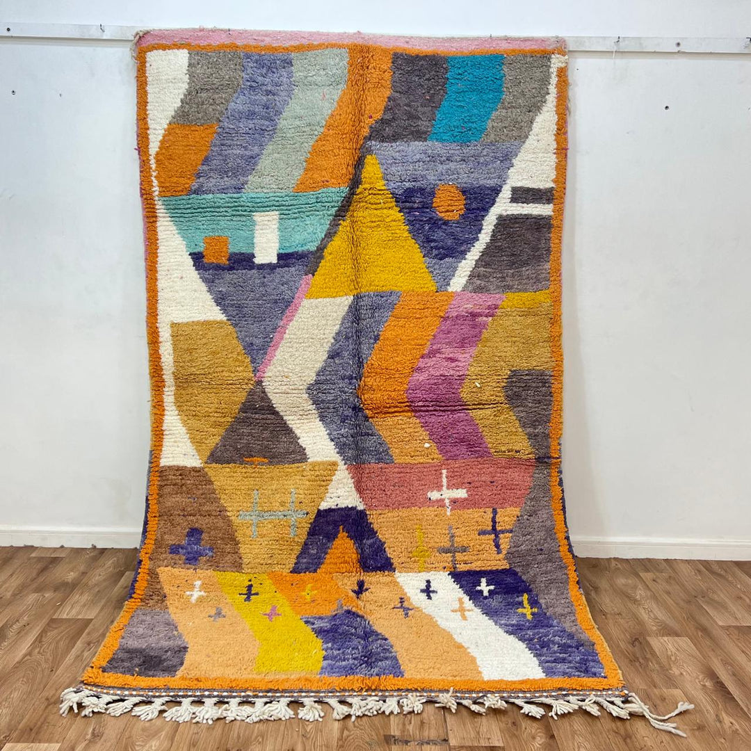 Vintage Moroccan wool rug 257 – handmade Berber rug with vibrant geometric design in orange, yellow, purple, and blue (264 × 162 cm).