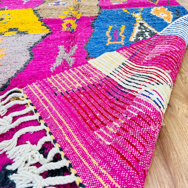 Vintage Moroccan rug with colorful Berber geometric patterns in pink, yellow, blue and red, handmade wool carpet from Morocco