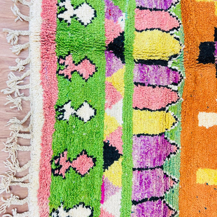 Vintage Moroccan wool rug with orange base and colorful Berber geometric patterns, handmade in Morocco
