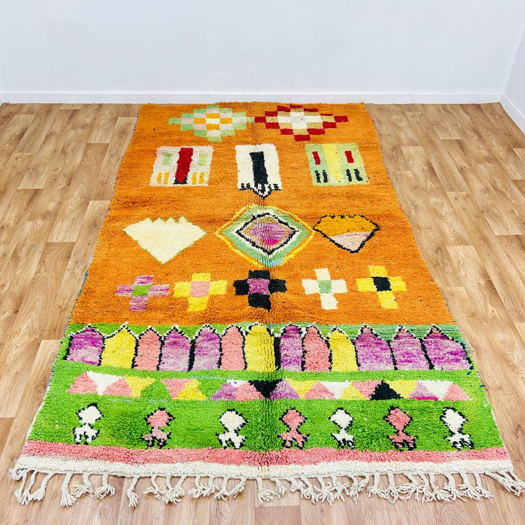 Vintage Moroccan wool rug with orange base and colorful Berber geometric patterns, handmade in Morocco
