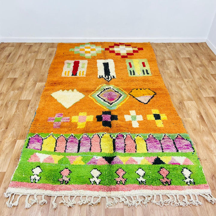Vintage Moroccan wool rug with orange base and colorful Berber geometric patterns, handmade in Morocco