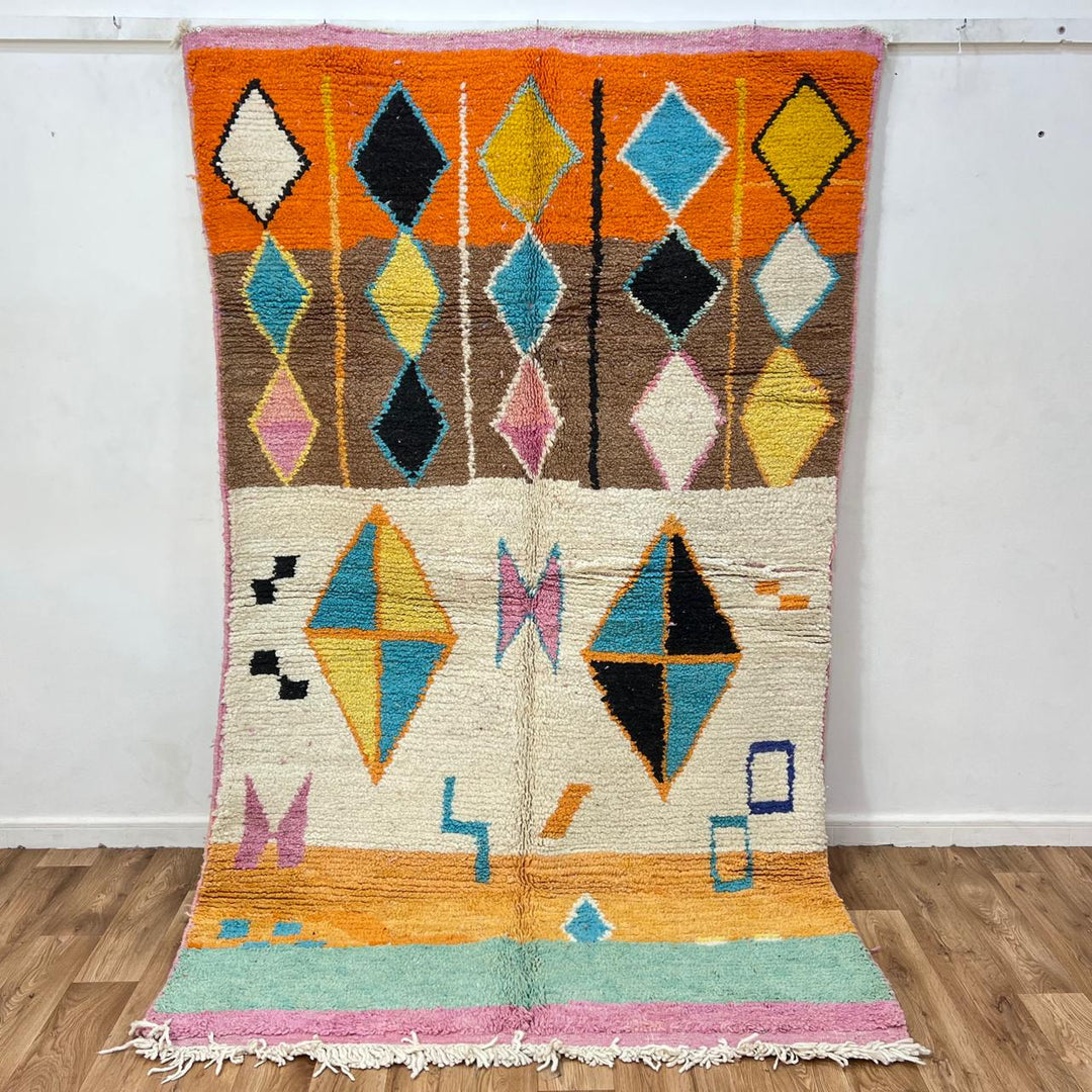 Vintage Moroccan wool rug 251 – handmade colorful geometric Berber rug with orange, turquoise, and yellow diamonds (252 × 150 cm).