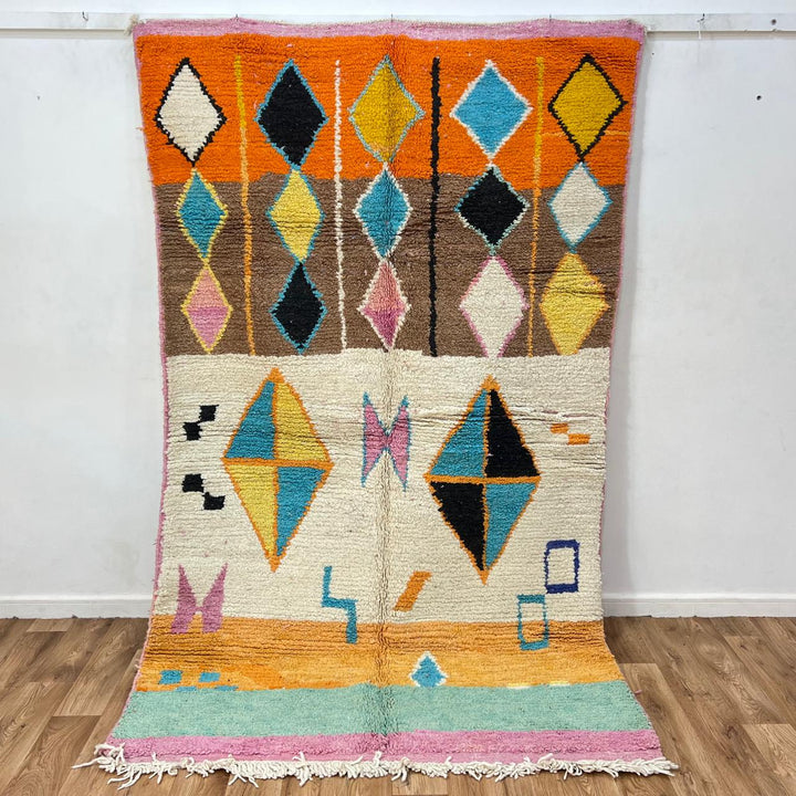 Vintage Moroccan wool rug 251 – handmade colorful geometric Berber rug with orange, turquoise, and yellow diamonds (252 × 150 cm).
