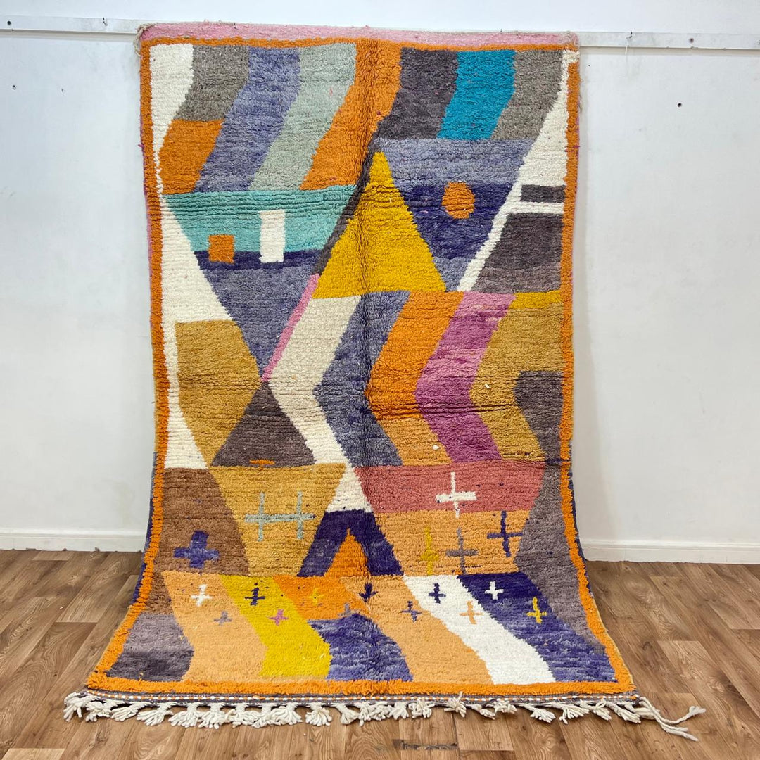 Vintage Moroccan wool rug 257 – handmade Berber rug with vibrant geometric design in orange, yellow, purple, and blue (264 × 162 cm).