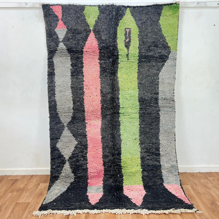 Vintage Moroccan wool rug 731 – handmade Berber carpet with black, green, pink, and grey abstract tribal patterns (233 × 147 cm / 7.64 × 4.82 ft).