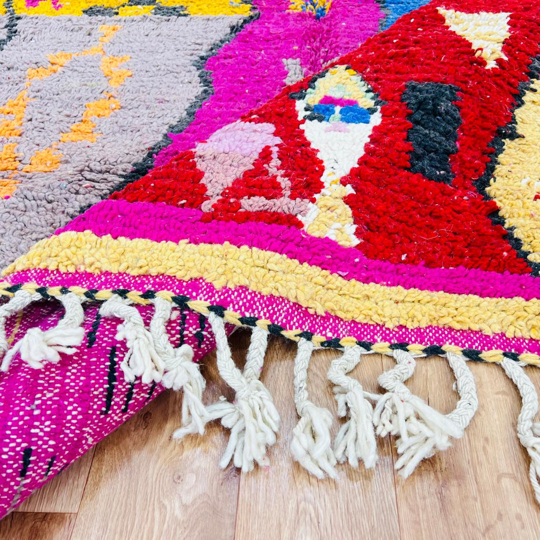 Vintage Moroccan rug with colorful Berber geometric patterns in pink, yellow, blue and red, handmade wool carpet from Morocco