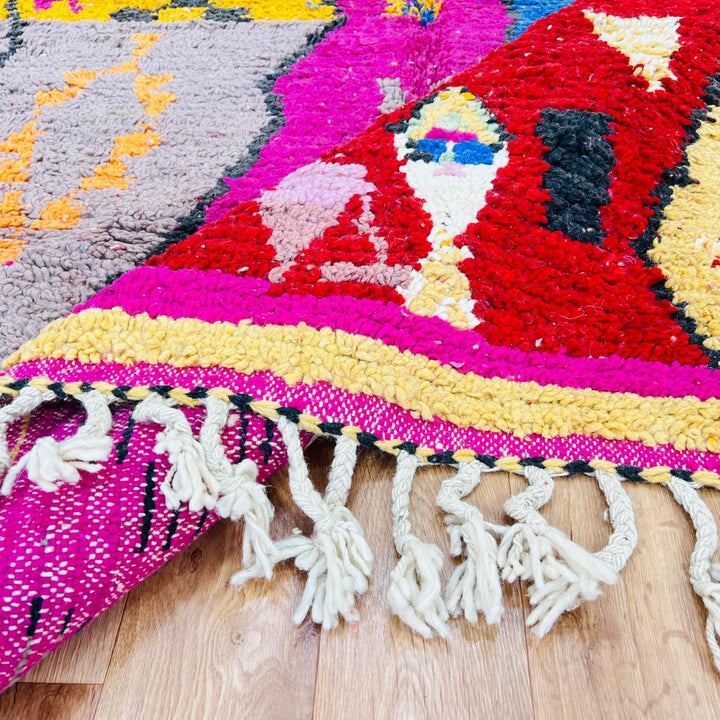 Vintage Moroccan rug with colorful Berber geometric patterns in pink, yellow, blue and red, handmade wool carpet from Morocco