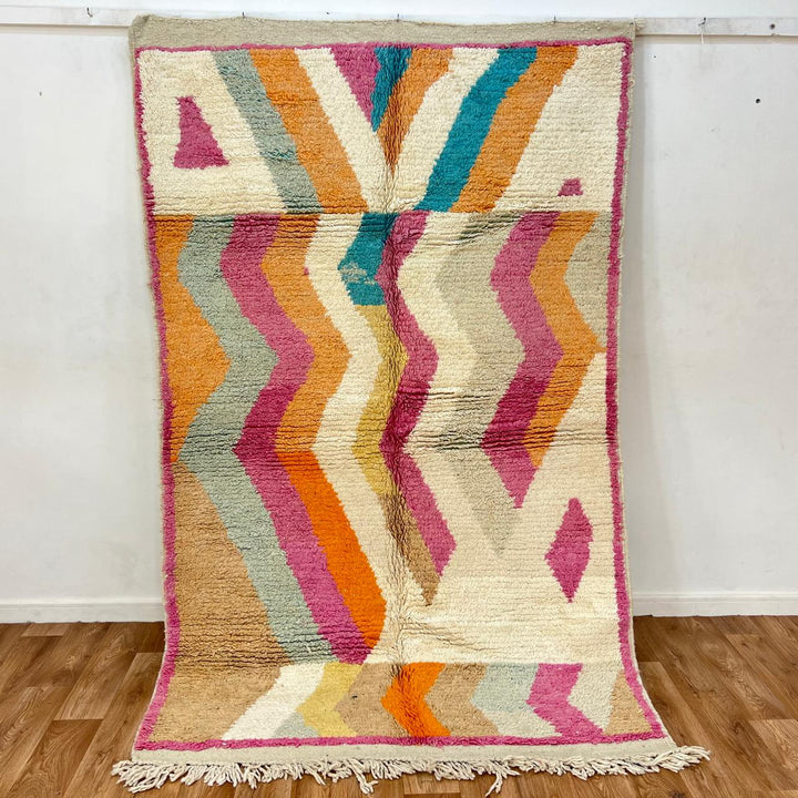 Vintage Moroccan wool rug 781 – handmade Berber carpet with zigzag chevron pattern in pink, orange, cream, and blue. 244 × 151 cm (8.01 × 4.95 ft).