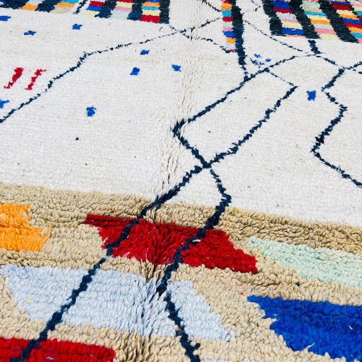 Vintage Moroccan Berber wool rug with ivory base, black tribal lines and colorful geometric accents