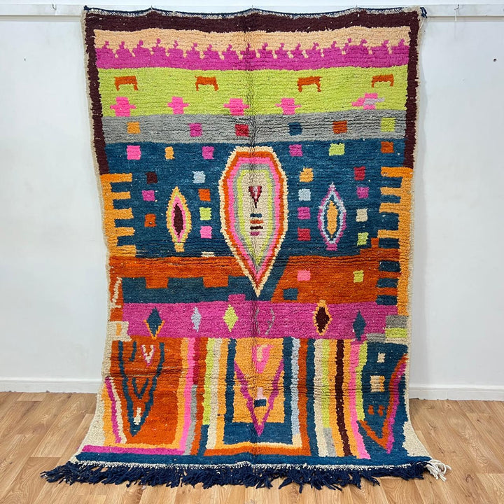 Vintage Moroccan wool rug 138 – handmade colorful geometric Berber design with pink, blue, and orange tones (234 × 162 cm).