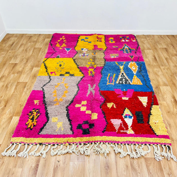 Vintage Moroccan rug with colorful Berber geometric patterns in pink, yellow, blue and red, handmade wool carpet from Morocco