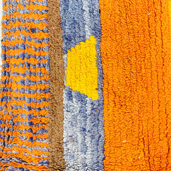 Vintage Moroccan wool rug with abstract geometric Berber design in mustard yellow, blue, and black, handmade in Morocco