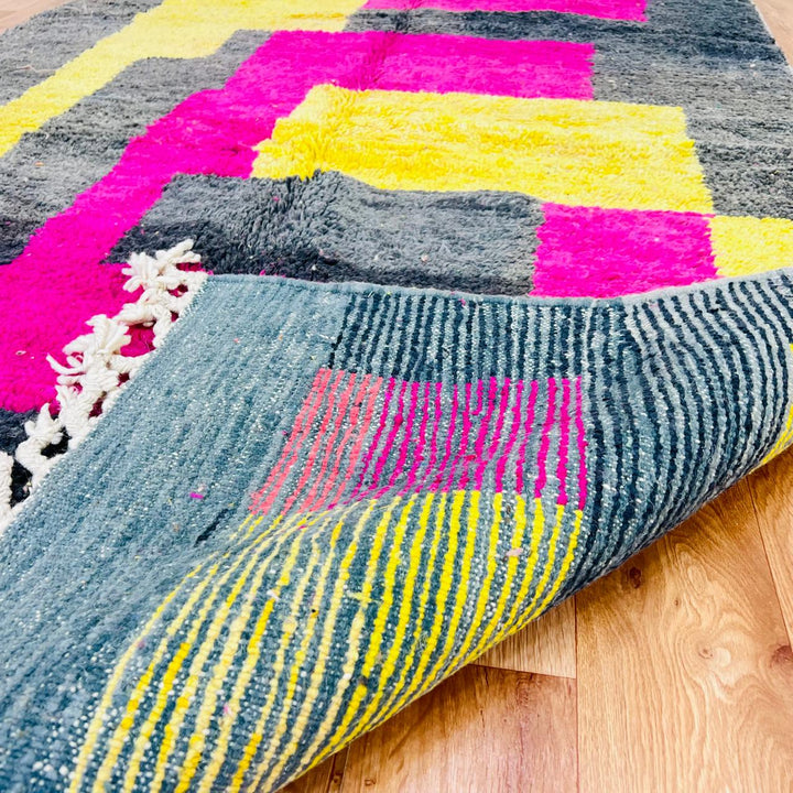 Vintage Moroccan wool rug with pink yellow and charcoal geometric pattern, handwoven Berber carpet from Morocco
