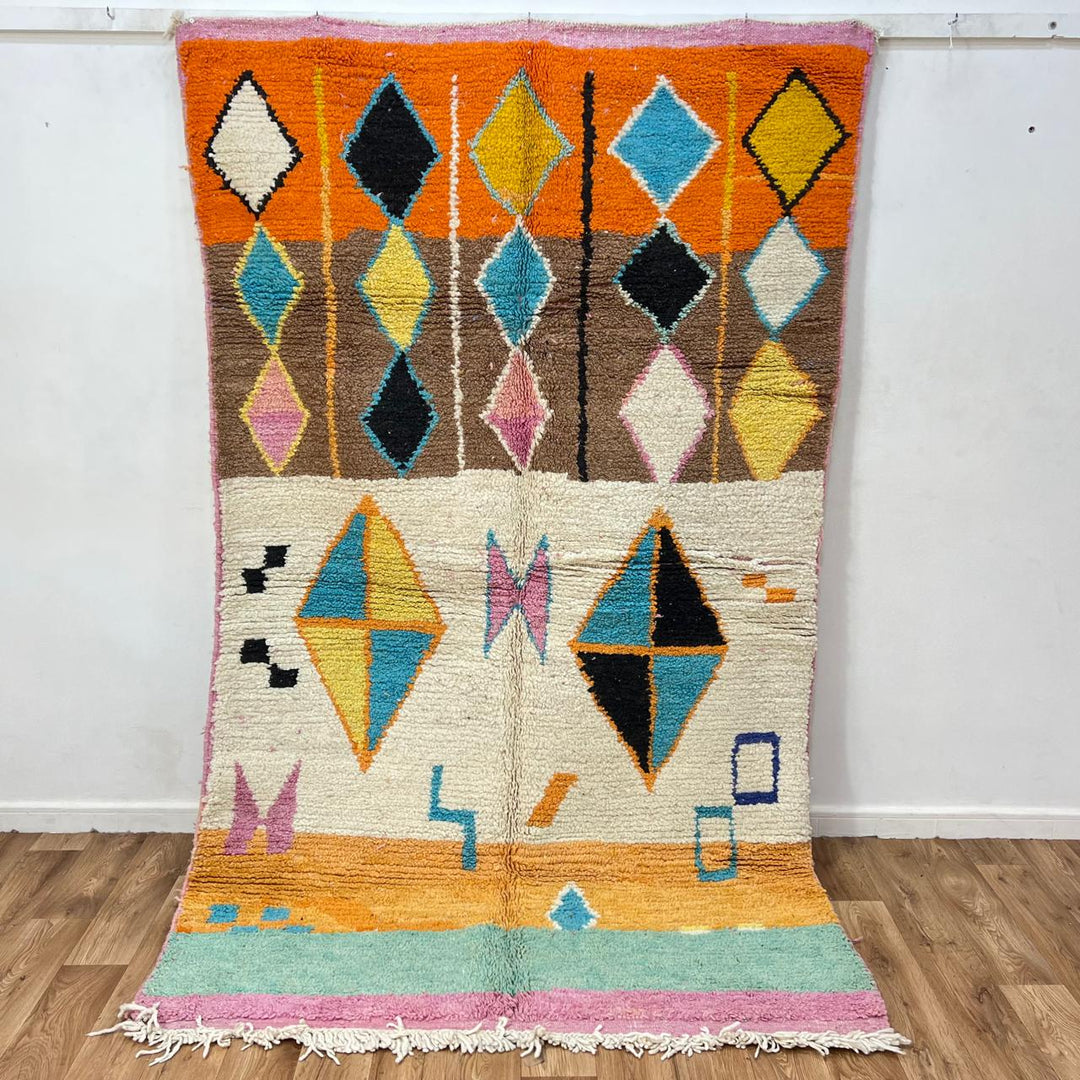 Vintage Moroccan wool rug 251 – handmade colorful geometric Berber rug with orange, turquoise, and yellow diamonds (252 × 150 cm).